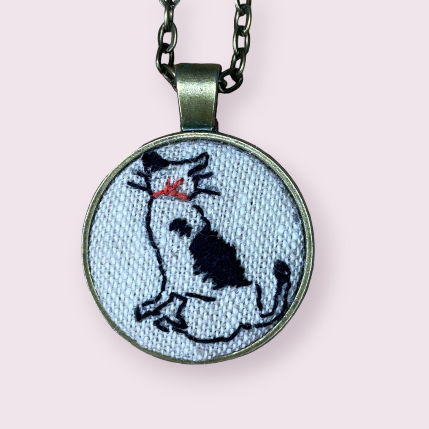 Hand embroidered cat looking away necklace