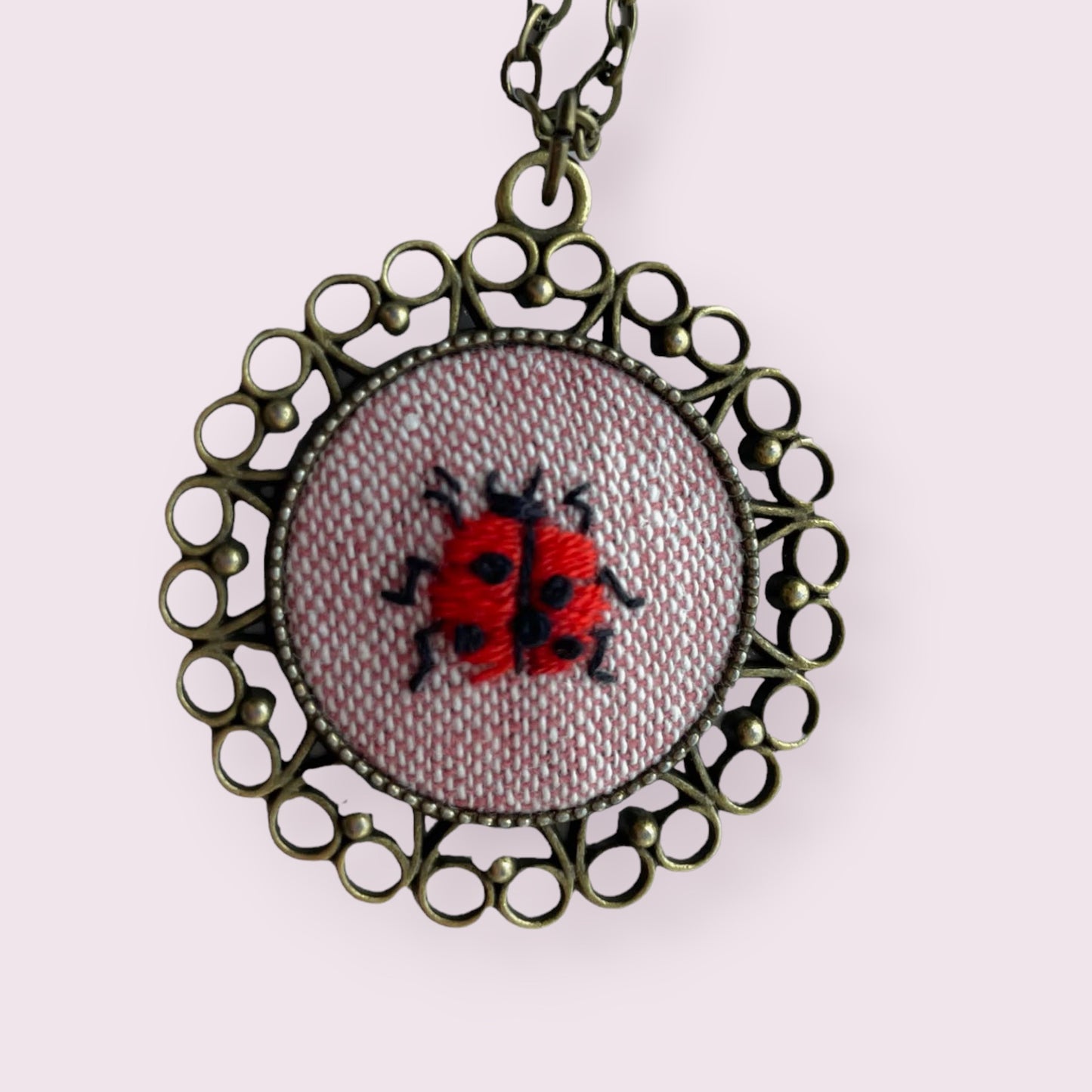 Hand embroidered lady bug necklace